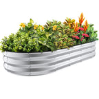 Silver 6x3x1 ft oval galvanized steel raised garden bed planted with vegetables and flowers, metal planter for outdoor gardening