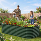 family gardening together using large raised garden bed in backyard vegetable garden