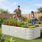 parents and kids gardening together using large raised bed in backyard